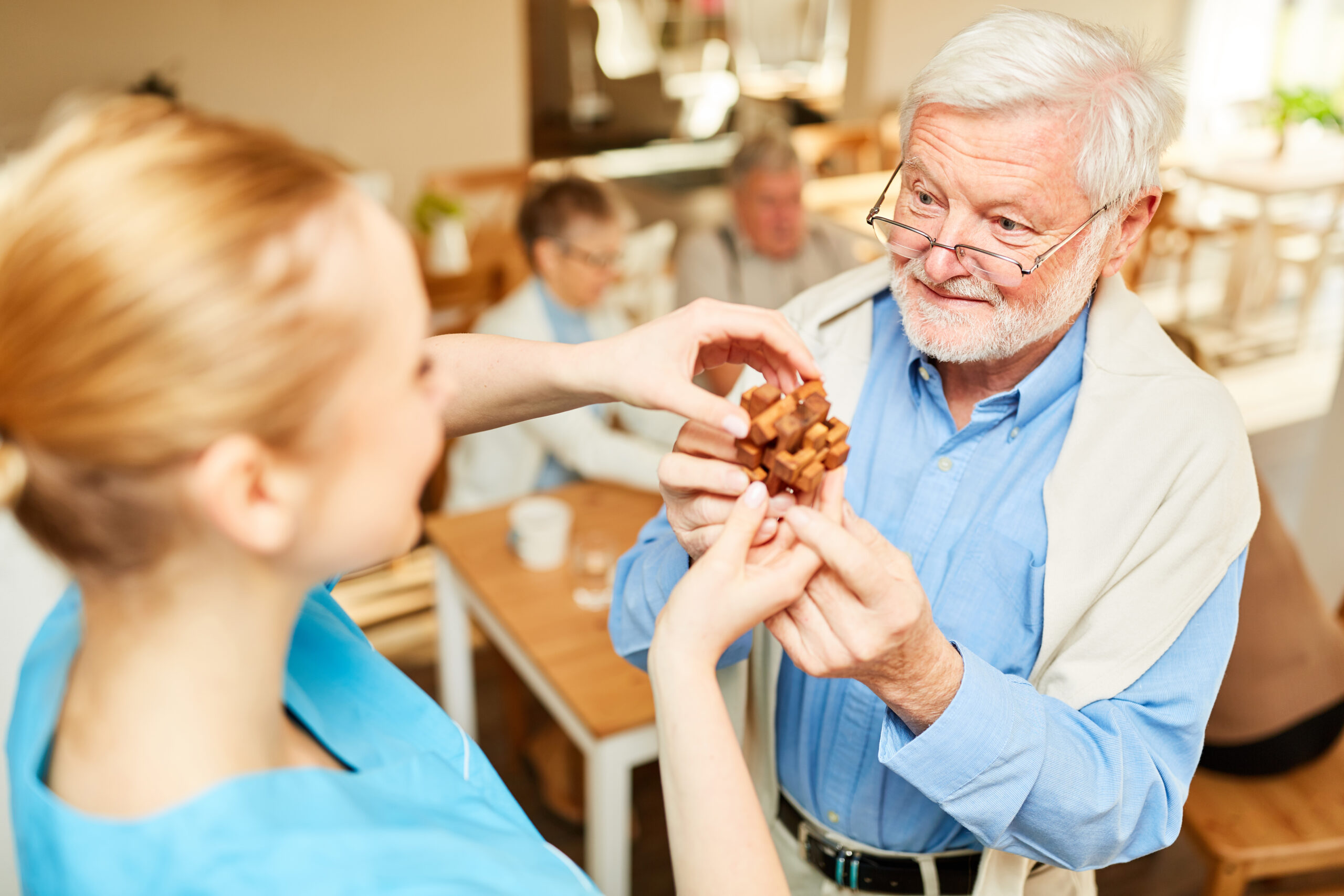 caregiver helping a senior man